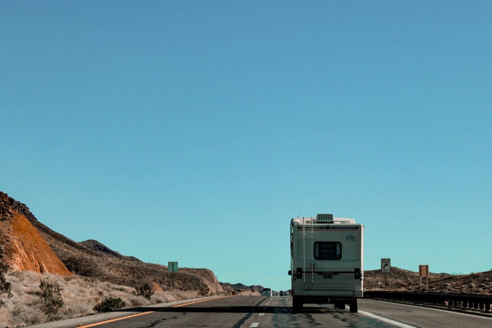 A motorhome travelling along an open desert highway
