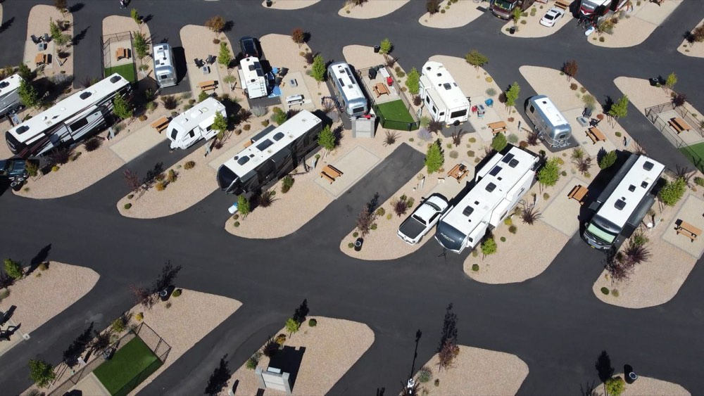 Aerial view of an RV park where each rig has its own gravel pad and picnic table